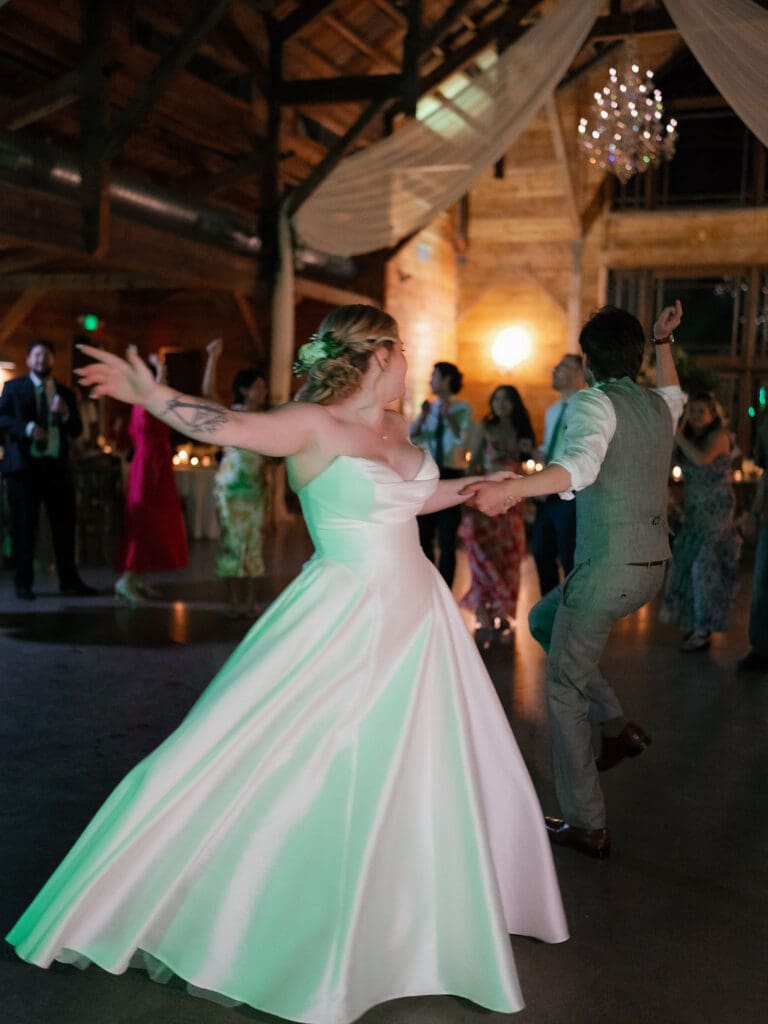 Dana and Jack dancing with guests on the wedding dance floor